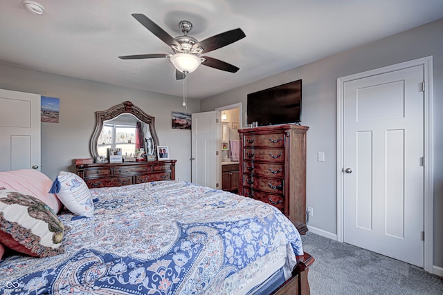 bedroom featuring carpet flooring, ensuite bath, and ceiling fan