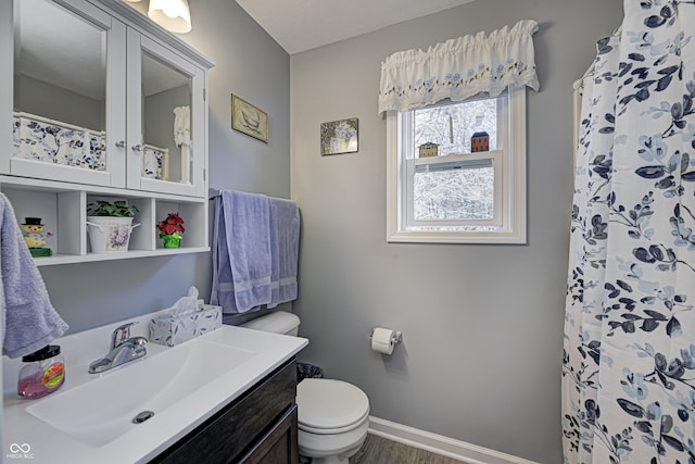 310 Jefferson, Coatesville, IN 46121 - full bathroom featuring toilet, vanity, baseboards, wood finished floors, and curtained shower