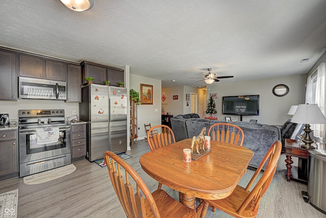310 Jefferson, Coatesville, IN 46121 - dining area with light wood finished floors, a ceiling fan, and a textured ceiling