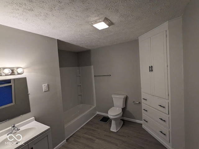 full bathroom with a textured ceiling, vanity, toilet, and hardwood / wood-style flooring