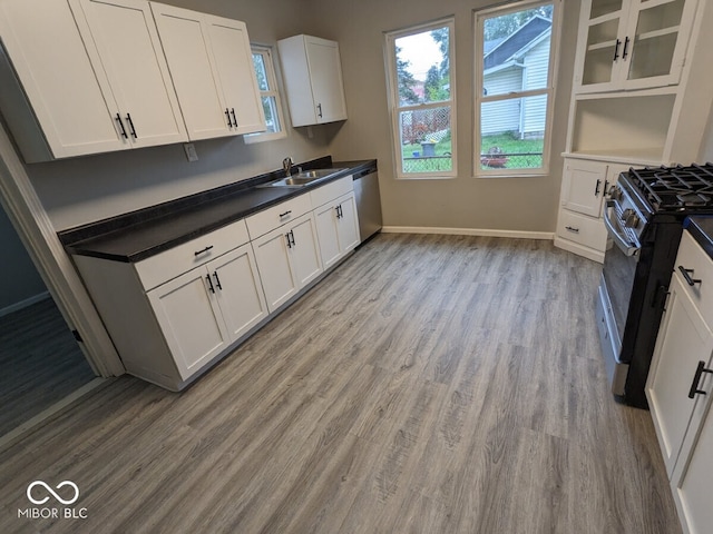 kitchen featuring light hardwood / wood-style flooring, white cabinets, appliances with stainless steel finishes, and sink