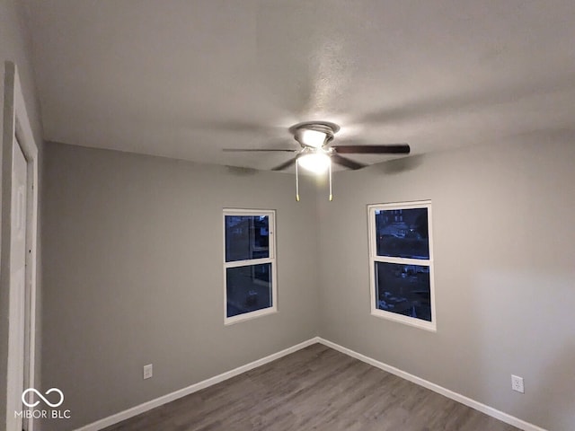 spare room featuring ceiling fan and hardwood / wood-style flooring