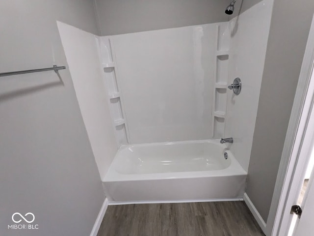 bathroom with tub / shower combination and hardwood / wood-style floors