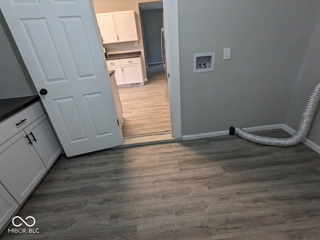 laundry room featuring washer hookup, cabinets, and dark hardwood / wood-style floors