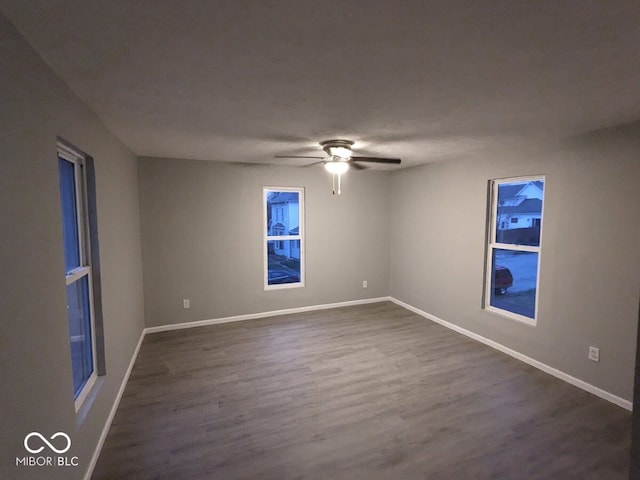 unfurnished room featuring ceiling fan and dark hardwood / wood-style floors