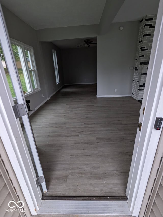 unfurnished room featuring ceiling fan and dark hardwood / wood-style flooring