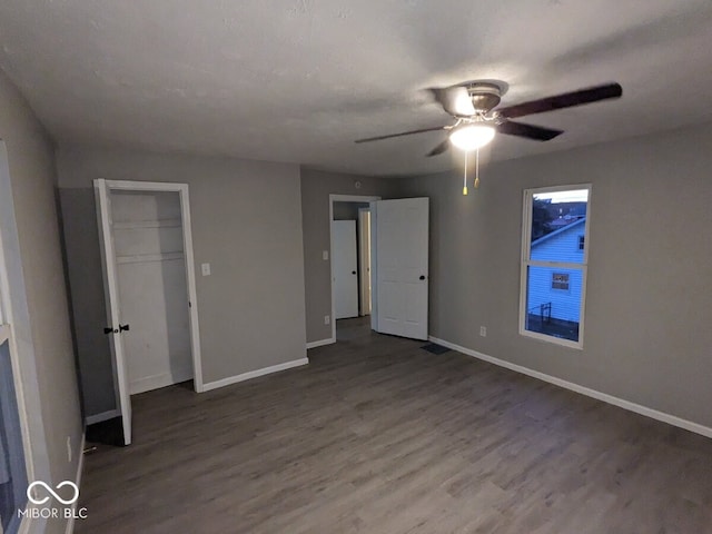 unfurnished bedroom featuring hardwood / wood-style floors and ceiling fan