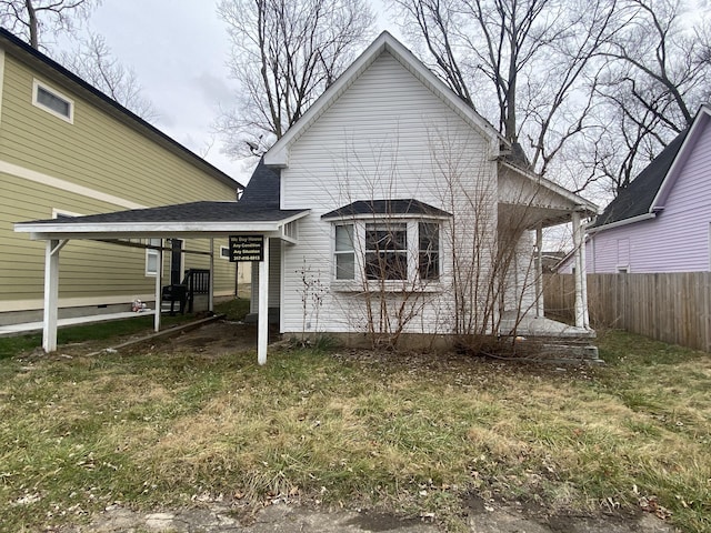 rear view of property featuring a yard