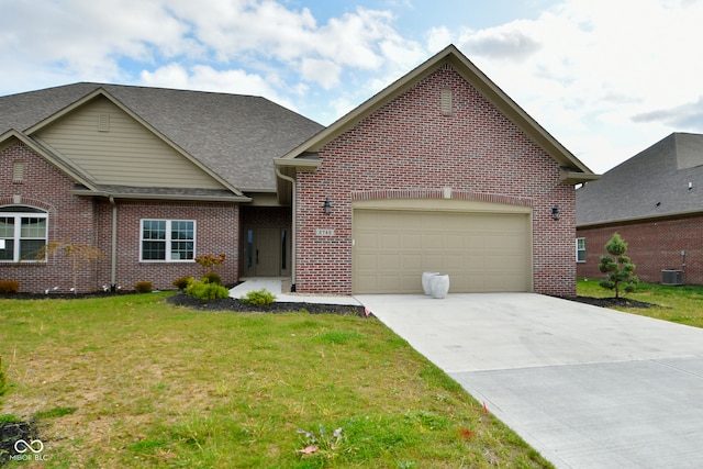 view of front of property with a garage, central air condition unit, and a front yard