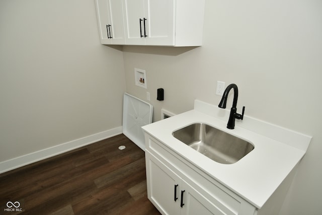 laundry area featuring dark hardwood / wood-style flooring, washer hookup, cabinets, and sink