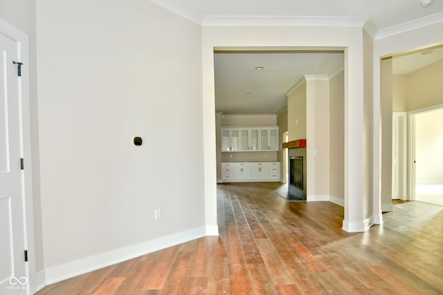 interior space with light wood-type flooring and ornamental molding