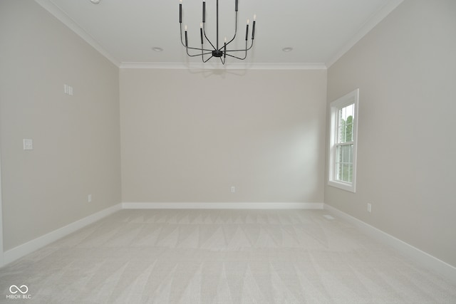 spare room with ornamental molding, light colored carpet, and a notable chandelier