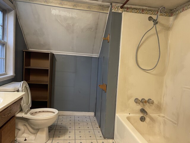 full bathroom featuring shower / bathtub combination, lofted ceiling, tile patterned floors, toilet, and vanity