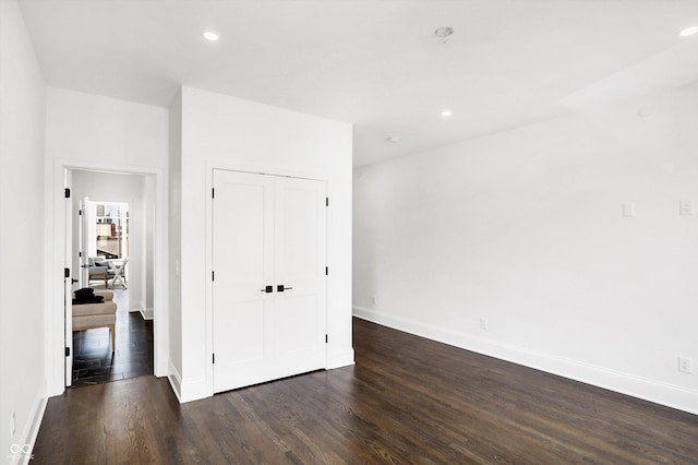 spare room featuring dark wood-type flooring