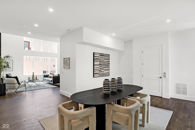 dining space with dark hardwood / wood-style flooring