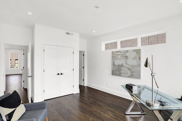 home office with dark wood-type flooring