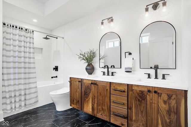 full bathroom with vanity, shower / tub combo, and toilet