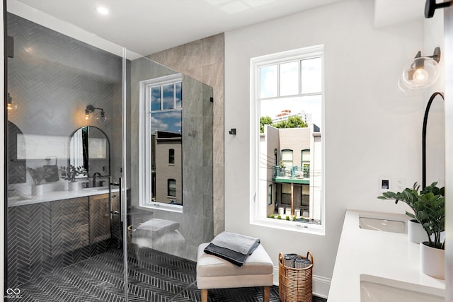 bathroom with an enclosed shower and vanity