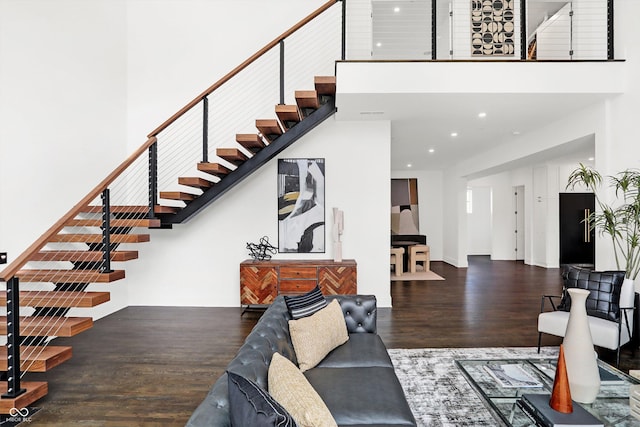 living room featuring dark hardwood / wood-style floors and a high ceiling