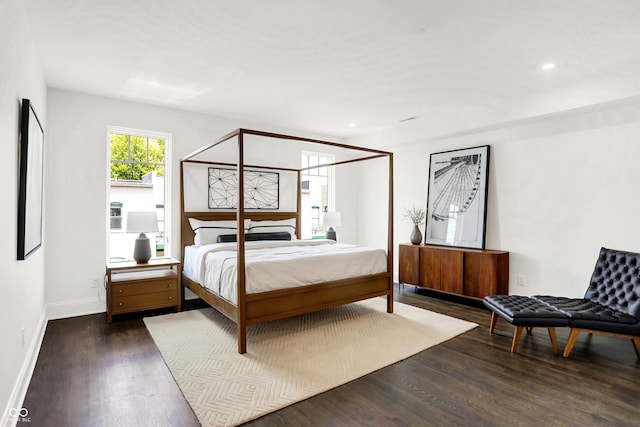 bedroom with dark hardwood / wood-style flooring