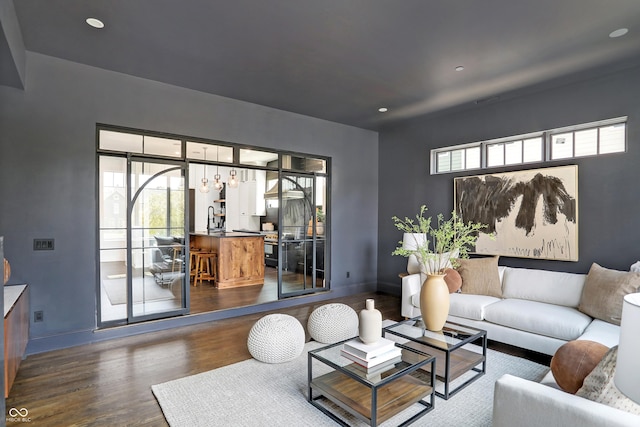 living room featuring sink and dark hardwood / wood-style floors