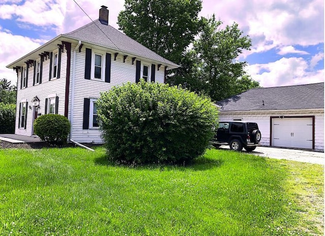 exterior space with a garage and a yard