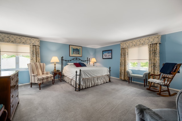 carpeted bedroom with multiple windows and ornamental molding