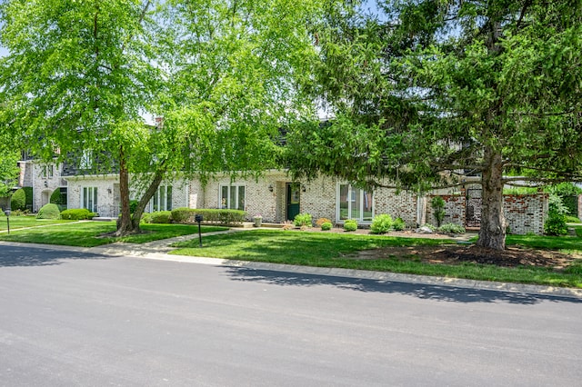 obstructed view of property featuring a front lawn