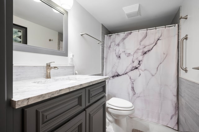 bathroom featuring a shower with curtain, vanity, tile walls, and toilet