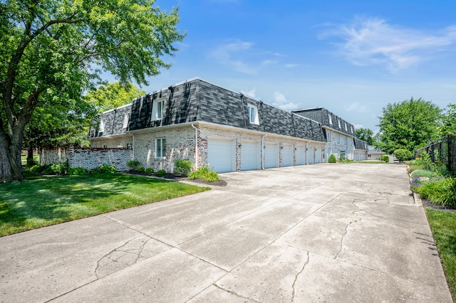 view of side of property with a lawn and a garage