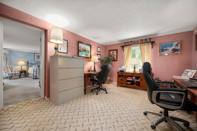 carpeted home office featuring a textured ceiling