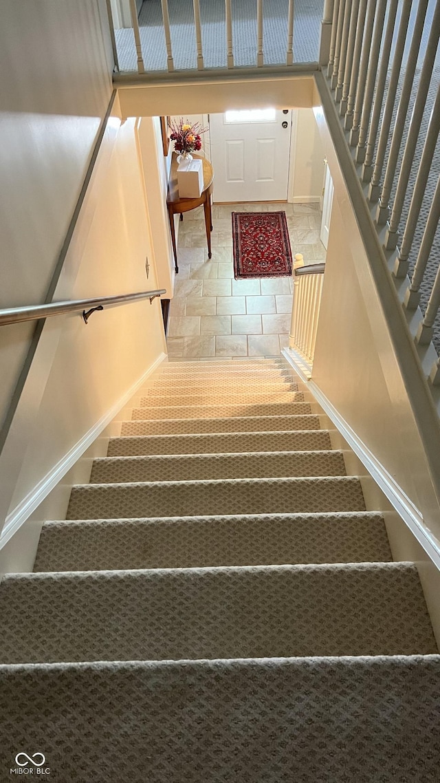 staircase with tile patterned floors