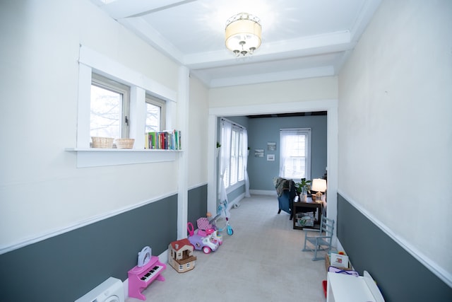 interior space with light colored carpet and beamed ceiling