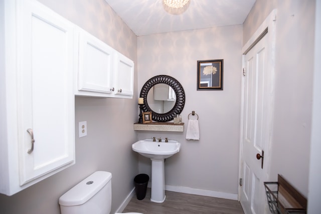 bathroom featuring sink, hardwood / wood-style floors, and toilet