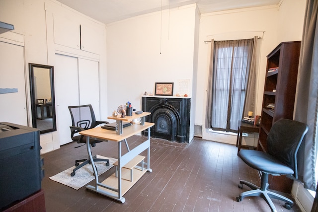 home office with dark hardwood / wood-style floors and ornamental molding