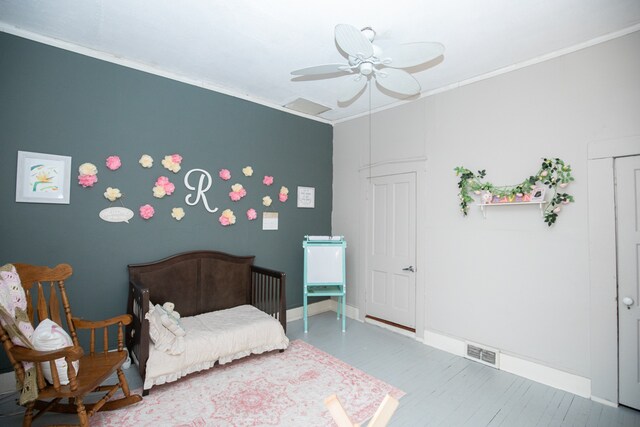 bedroom with ceiling fan and ornamental molding