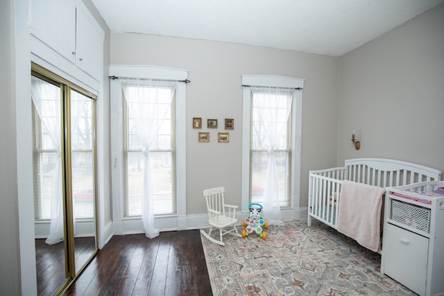 bedroom featuring hardwood / wood-style flooring and multiple windows