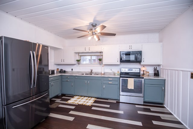 kitchen with white cabinets, stainless steel appliances, sink, dark hardwood / wood-style floors, and ceiling fan