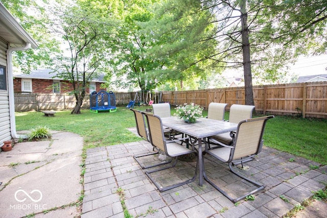 view of patio featuring a playground and a trampoline