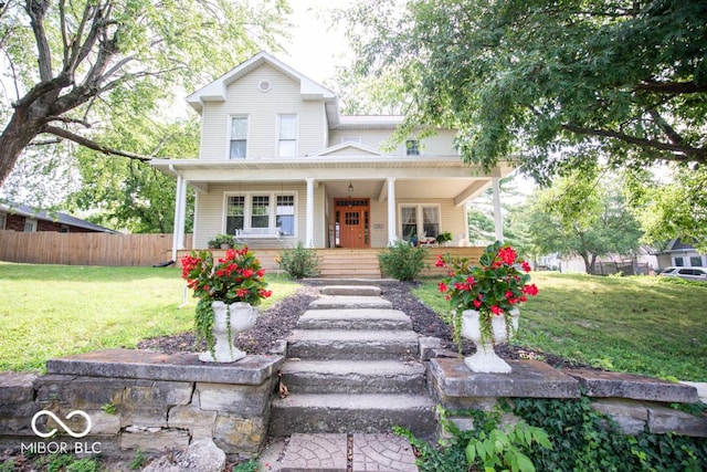 view of front facade featuring covered porch and a front yard