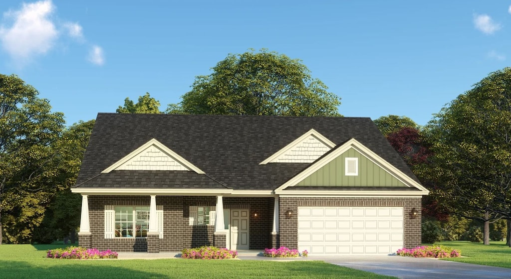 view of front of house with a front yard and a garage