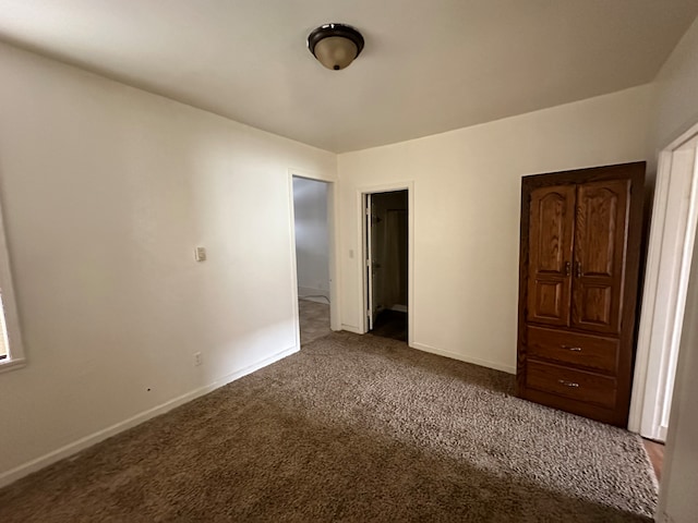 unfurnished bedroom with dark colored carpet