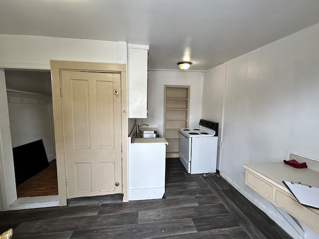 kitchen featuring white cabinets, dark hardwood / wood-style floors, electric range, and sink