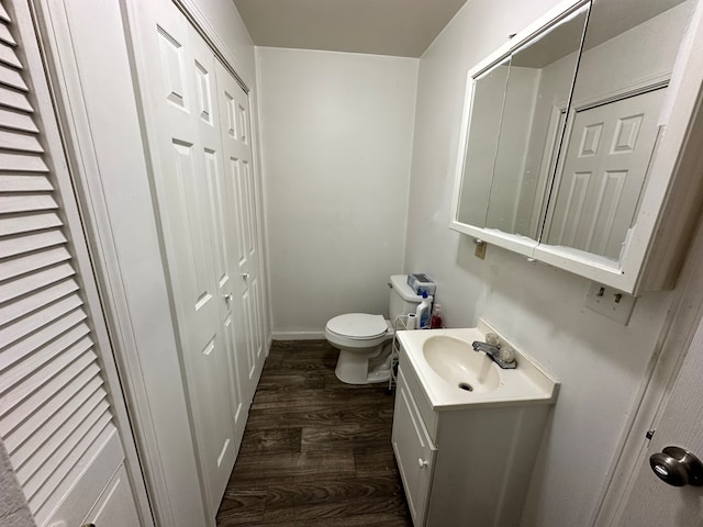 bathroom featuring toilet, hardwood / wood-style floors, and oversized vanity