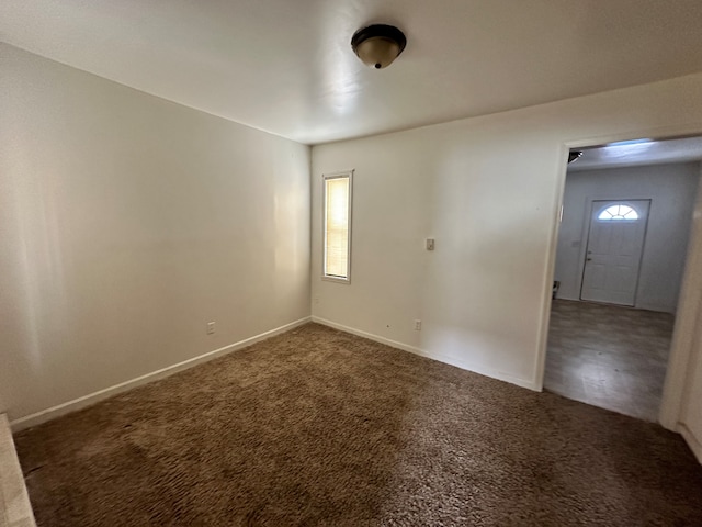 empty room featuring dark colored carpet