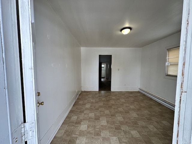 spare room featuring a baseboard radiator and tile flooring