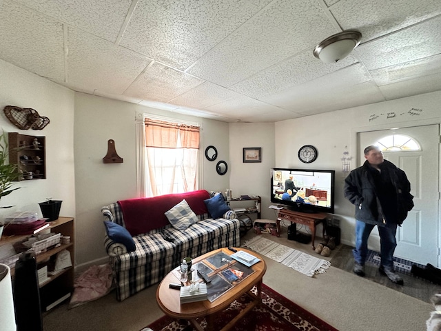 living room featuring a drop ceiling