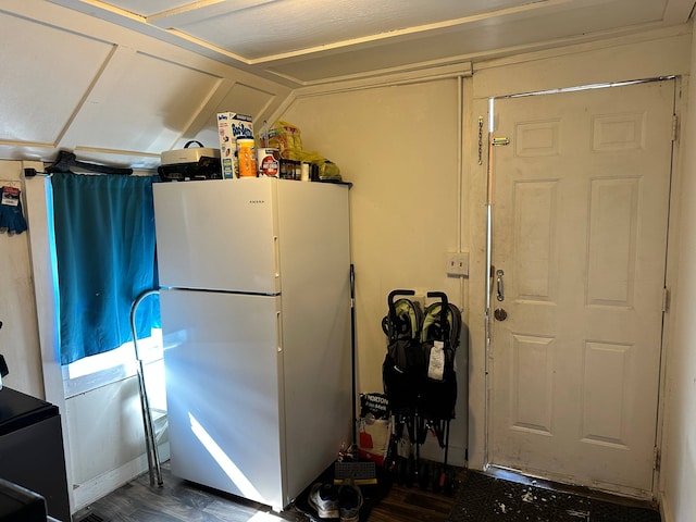 kitchen with dark hardwood / wood-style flooring and white fridge