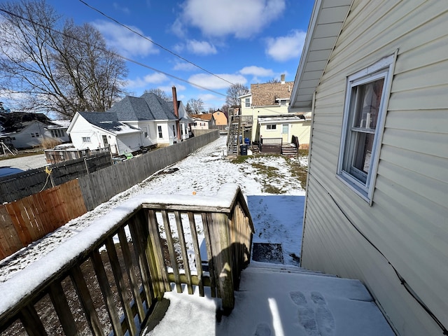 view of snow covered back of property