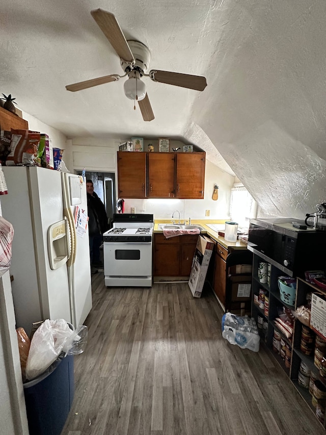 kitchen with dark hardwood / wood-style flooring, lofted ceiling, a textured ceiling, ceiling fan, and white appliances